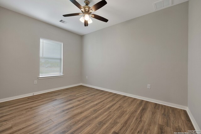 unfurnished room featuring ceiling fan and dark hardwood / wood-style flooring