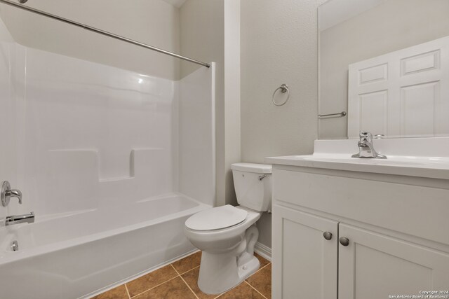 full bathroom featuring vanity, shower / bath combination, tile patterned floors, and toilet