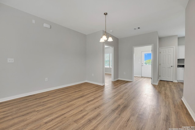518 Precious Dr, San Antonio, TX 78237 - spare room featuring baseboards, visible vents, an inviting chandelier, and light wood finished floors
