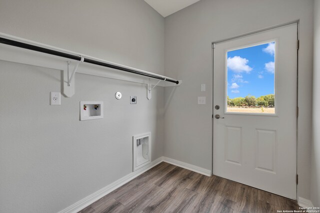 laundry area featuring hookup for an electric dryer, dark wood-type flooring, hookup for a washing machine, and gas dryer hookup