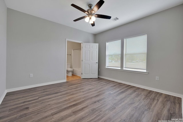 518 Precious Dr, San Antonio, TX 78237 - unfurnished bedroom with baseboards, ensuite bathroom, wood finished floors, and visible vents