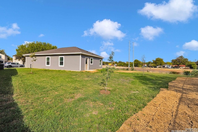view of side of property with a yard