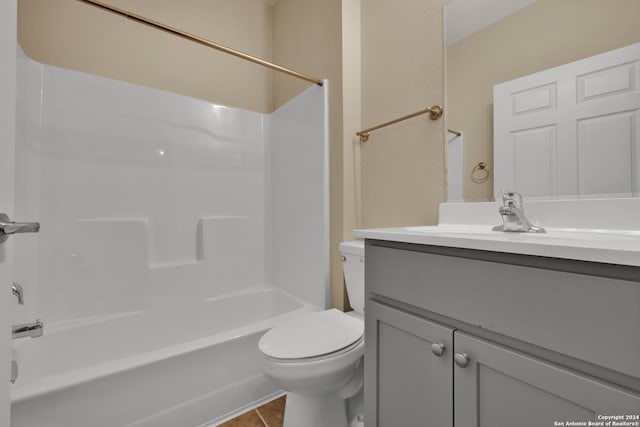 bathroom featuring toilet, tile patterned flooring, vanity, and shower / bathing tub combination