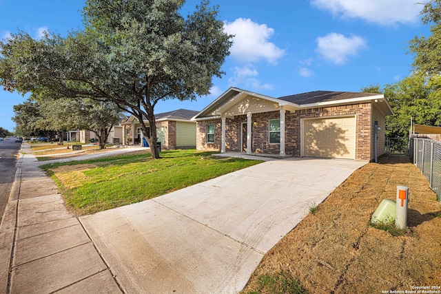 ranch-style house featuring a front yard and a garage