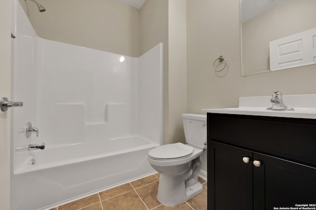 full bathroom featuring toilet, vanity, washtub / shower combination, and tile patterned flooring