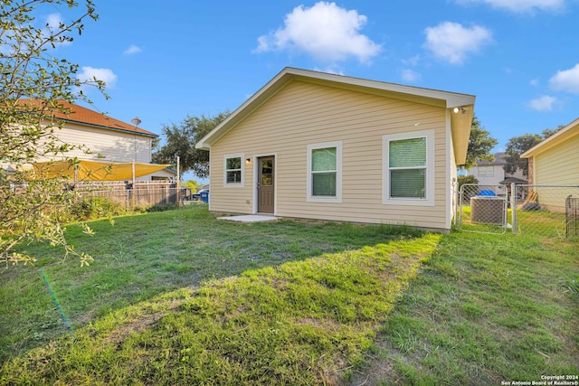 rear view of property with a lawn