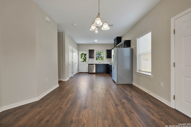 kitchen featuring an inviting chandelier, dark wood-type flooring, appliances with stainless steel finishes, and a healthy amount of sunlight