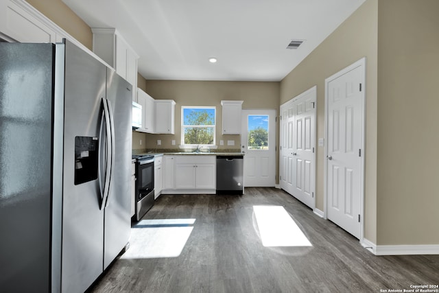 kitchen featuring white cabinetry, appliances with stainless steel finishes, dark hardwood / wood-style flooring, and sink