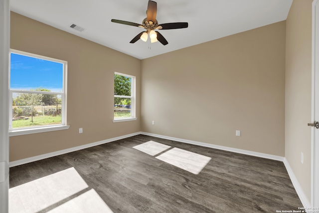 spare room with ceiling fan and dark hardwood / wood-style flooring