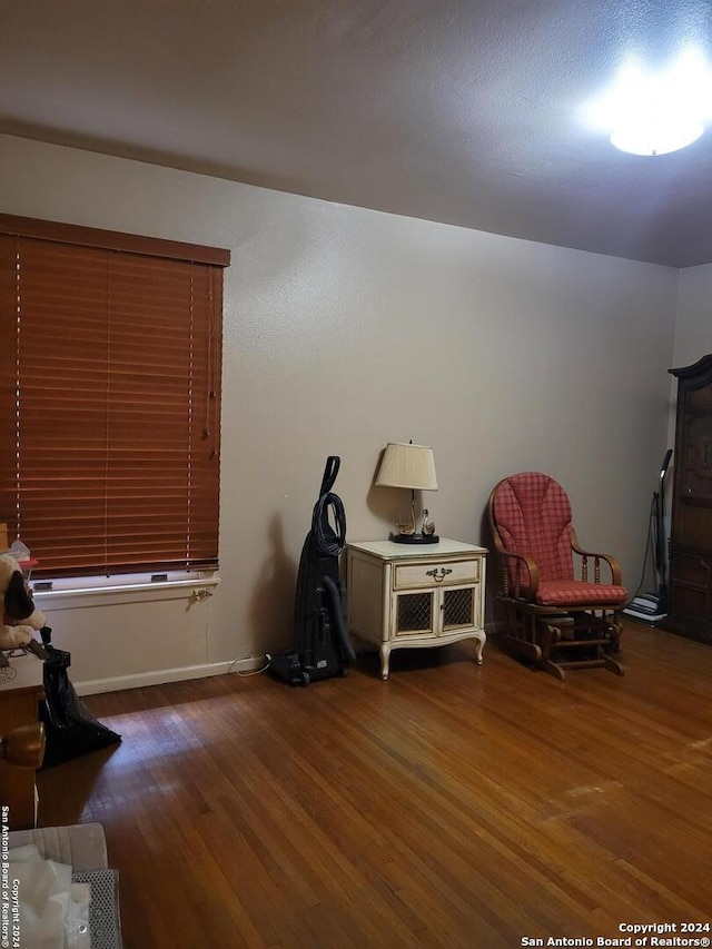 sitting room with dark wood-type flooring