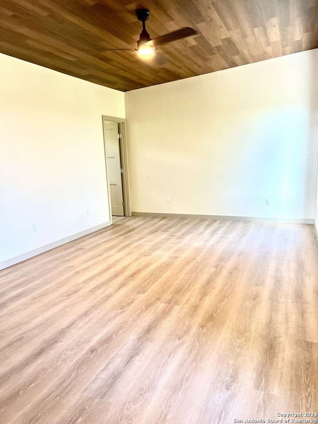 spare room with wooden ceiling, light wood-type flooring, and ceiling fan