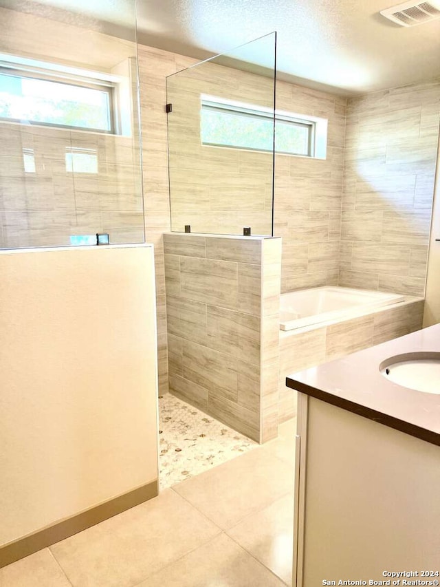 bathroom featuring vanity, separate shower and tub, and tile patterned floors