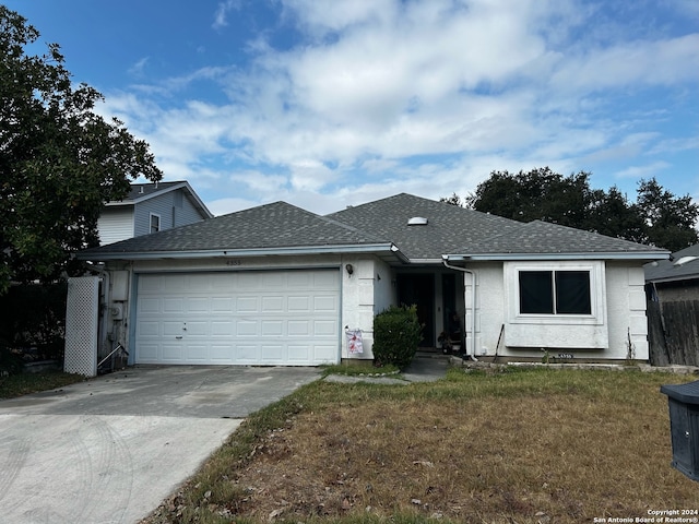 ranch-style house with a front lawn and a garage