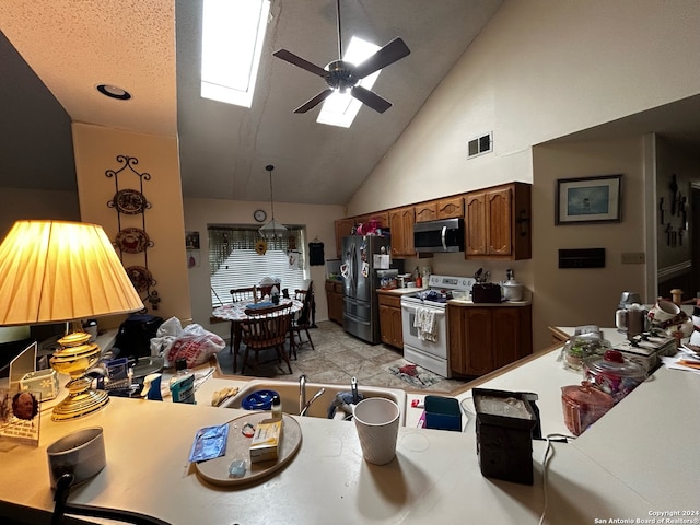 kitchen with ceiling fan, high vaulted ceiling, white electric stove, a skylight, and refrigerator