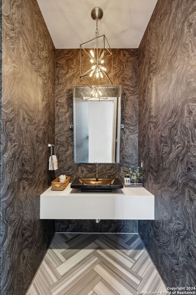 bathroom featuring vanity and a chandelier