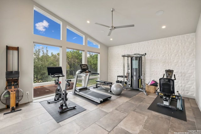 workout room with high vaulted ceiling and ceiling fan