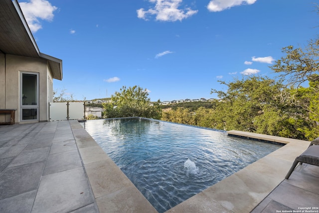 view of swimming pool with a patio area