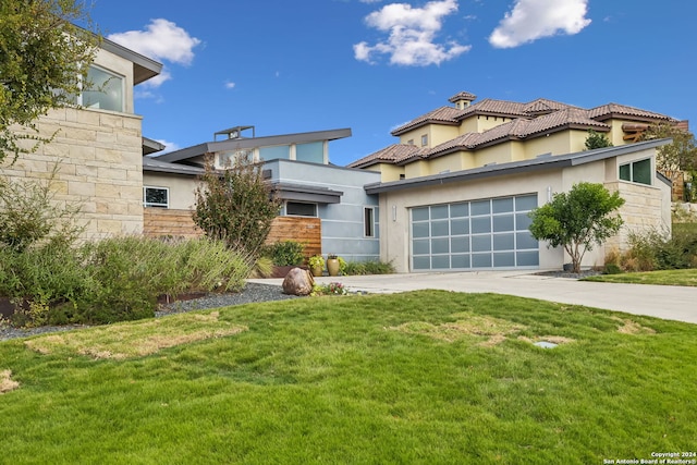 view of front of home with a front yard and a garage