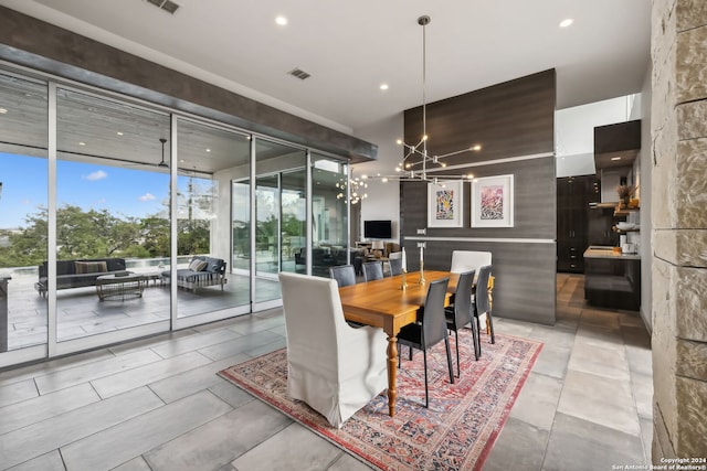 dining area featuring a chandelier and floor to ceiling windows