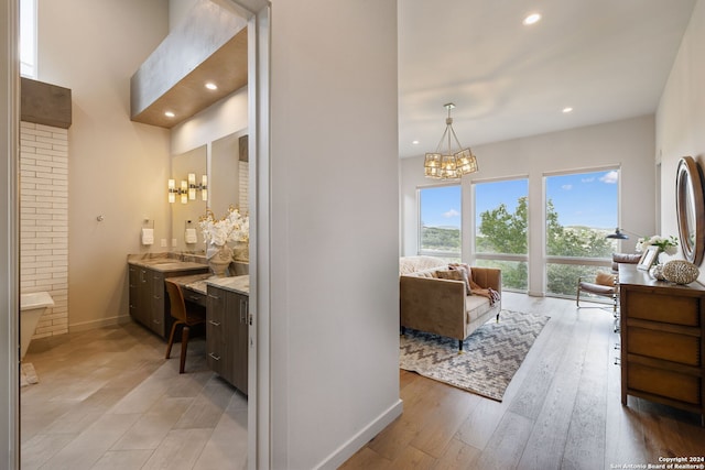 bathroom with vanity, hardwood / wood-style floors, and a chandelier