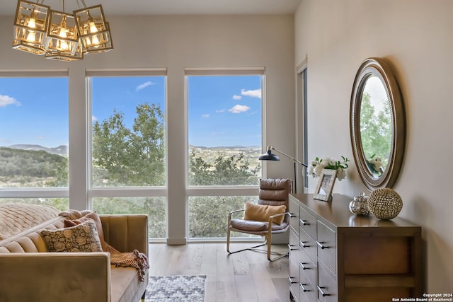 sitting room featuring a mountain view, light hardwood / wood-style floors, and plenty of natural light