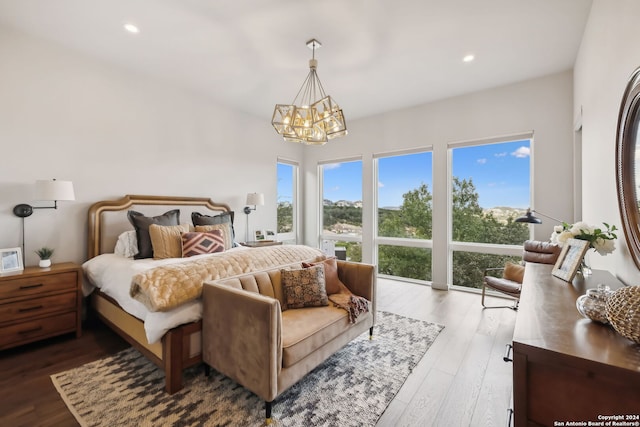 bedroom featuring light hardwood / wood-style flooring and a chandelier