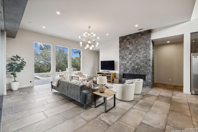 tiled living room with a stone fireplace and an inviting chandelier