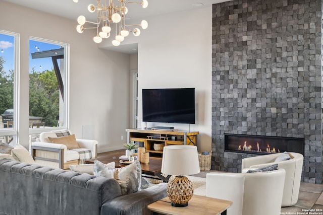 living room featuring hardwood / wood-style flooring, a chandelier, and a fireplace