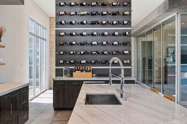 wine room with sink and light tile patterned floors