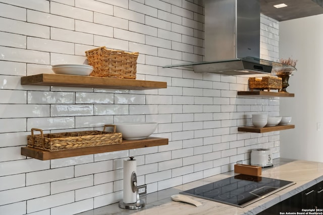 kitchen featuring black electric stovetop, backsplash, and wall chimney exhaust hood