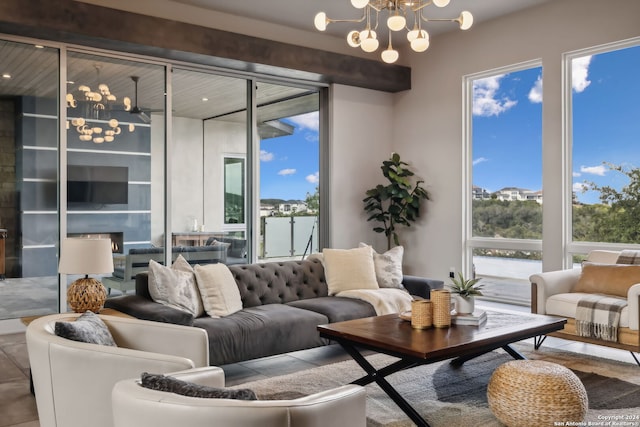 living room with a notable chandelier and plenty of natural light