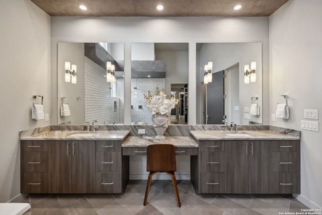 bathroom featuring vanity, a shower, and tile patterned flooring