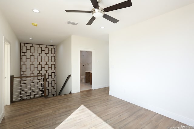 empty room featuring hardwood / wood-style floors and ceiling fan