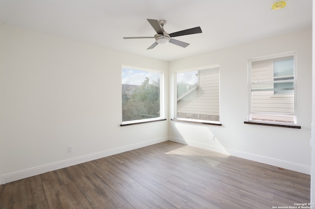 empty room featuring hardwood / wood-style flooring and ceiling fan