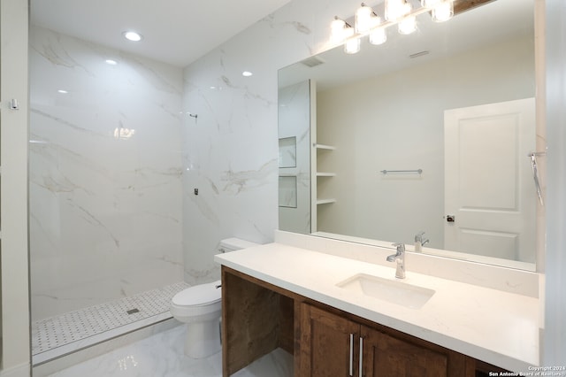 bathroom with vanity, toilet, and a tile shower