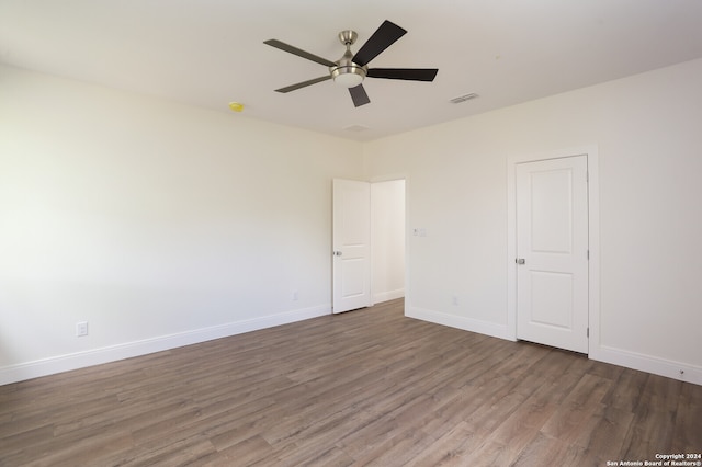 empty room featuring hardwood / wood-style floors and ceiling fan