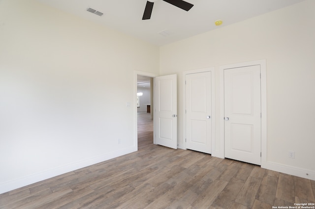 unfurnished bedroom with light hardwood / wood-style floors and ceiling fan