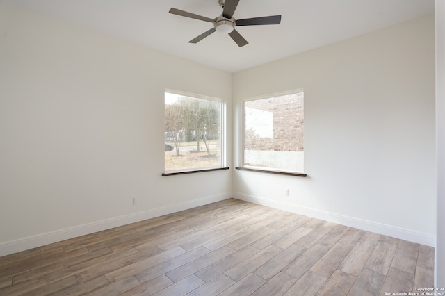 unfurnished room with light wood-type flooring and ceiling fan