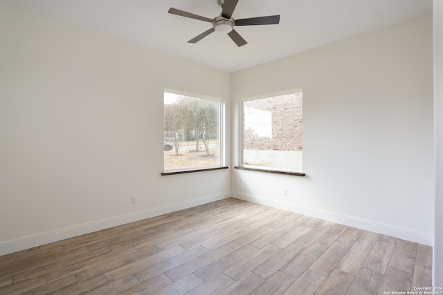 empty room with light wood-type flooring and ceiling fan