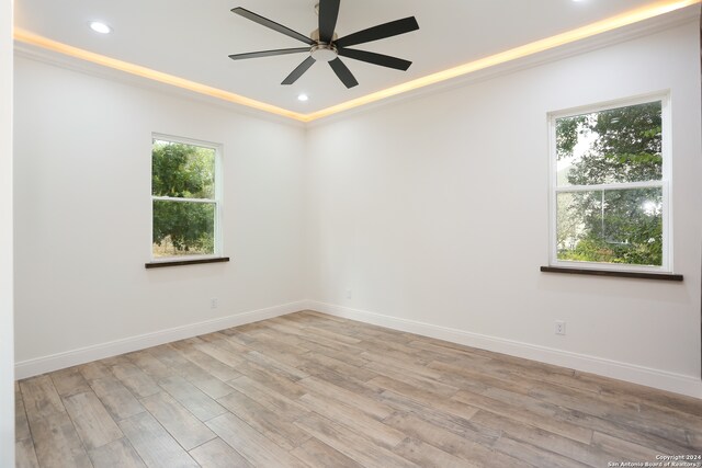 unfurnished room featuring light hardwood / wood-style flooring, ornamental molding, and ceiling fan