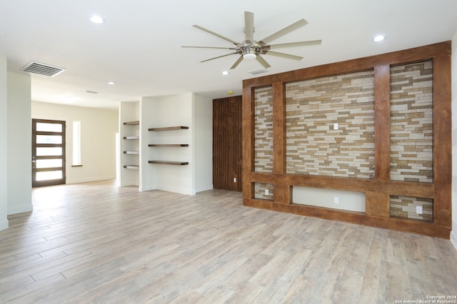 unfurnished living room with ceiling fan and light hardwood / wood-style flooring