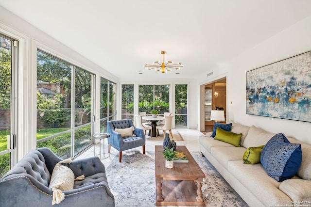 sunroom / solarium featuring an inviting chandelier