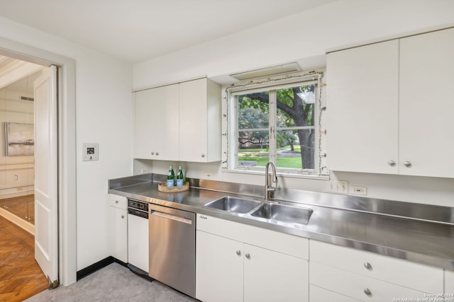 kitchen featuring white cabinets, stainless steel dishwasher, sink, and stainless steel counters