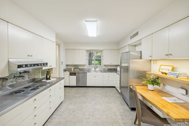 800 Ivy Ln, Terrell Hills, TX 78209 - kitchen featuring stainless steel counters, stainless steel appliances, a sink, under cabinet range hood, and white cabinetry