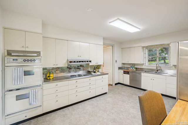 800 Ivy Ln, Terrell Hills, TX 78209 - kitchen with stainless steel counters, a sink, appliances with stainless steel finishes, under cabinet range hood, and white cabinetry