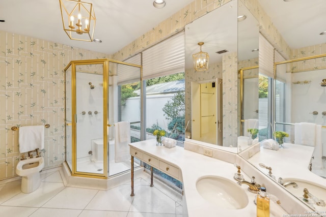 bathroom featuring a wealth of natural light, a shower with shower door, vanity, and tile patterned flooring