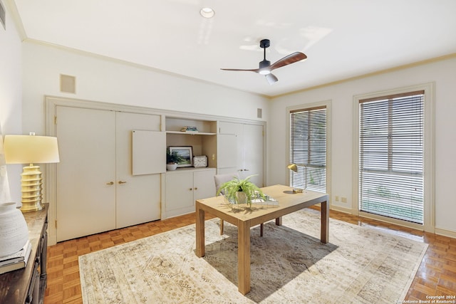 home office featuring parquet flooring, ceiling fan, and crown molding