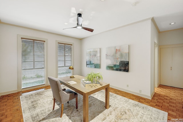 home office featuring ceiling fan, light parquet floors, and crown molding