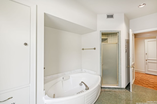 bathroom featuring shower with separate bathtub