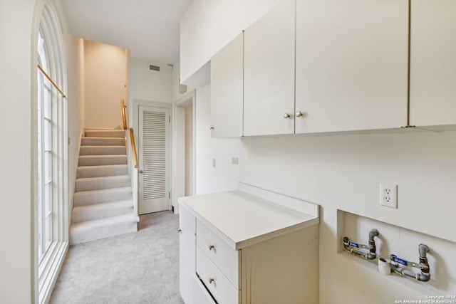 800 Ivy Ln, Terrell Hills, TX 78209 - kitchen featuring light countertops, white cabinetry, and light colored carpet